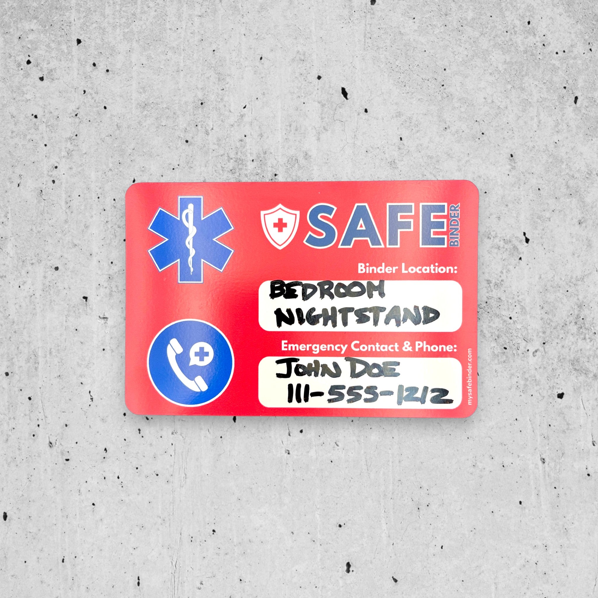 Red SAFE Binder magnet with medical symbols on a gray concrete surface