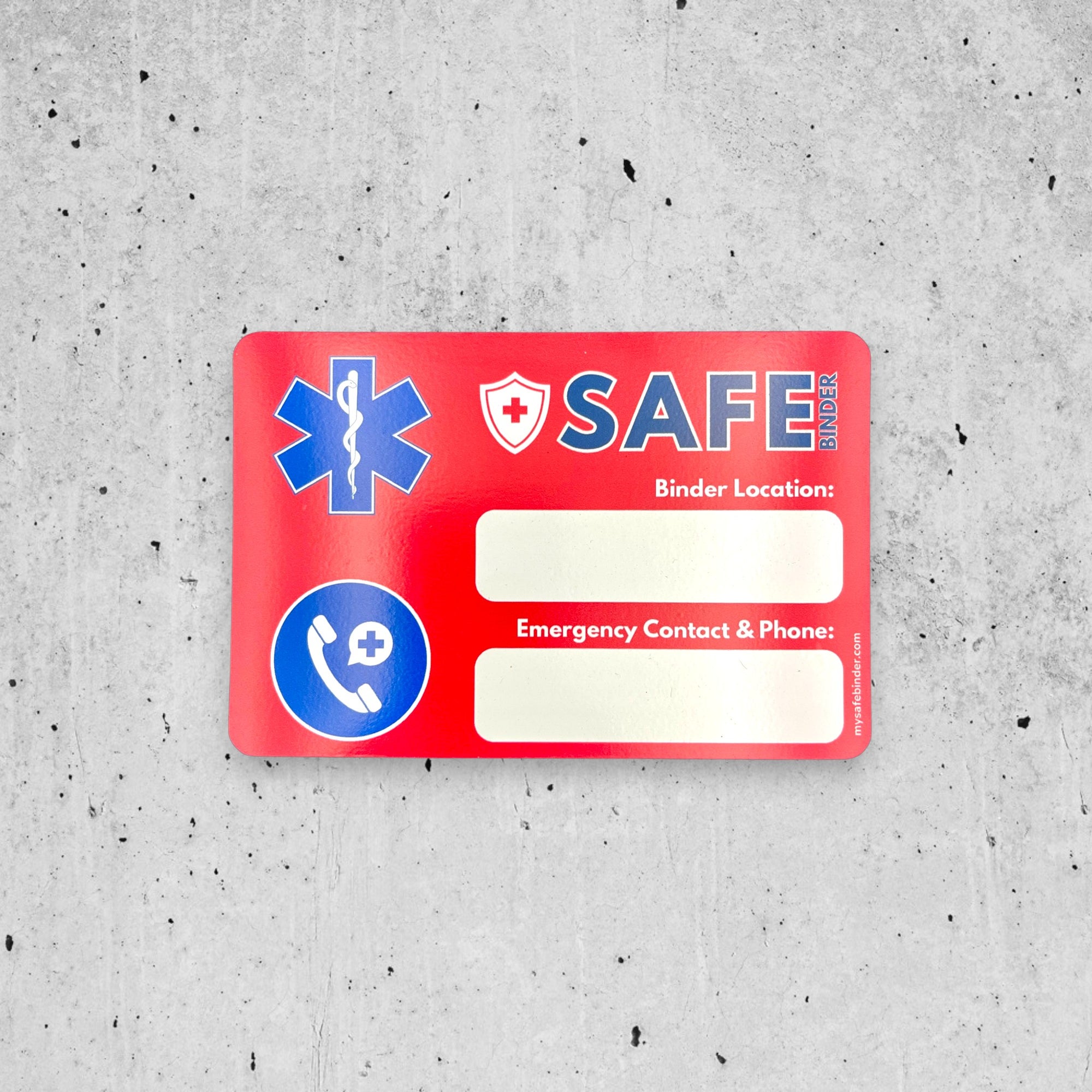 Red SAFE Binder magnet with medical symbols on a gray concrete surface