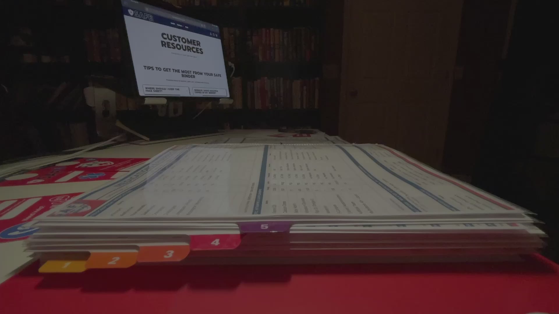 A hand flipping pages of a SAFE Binder