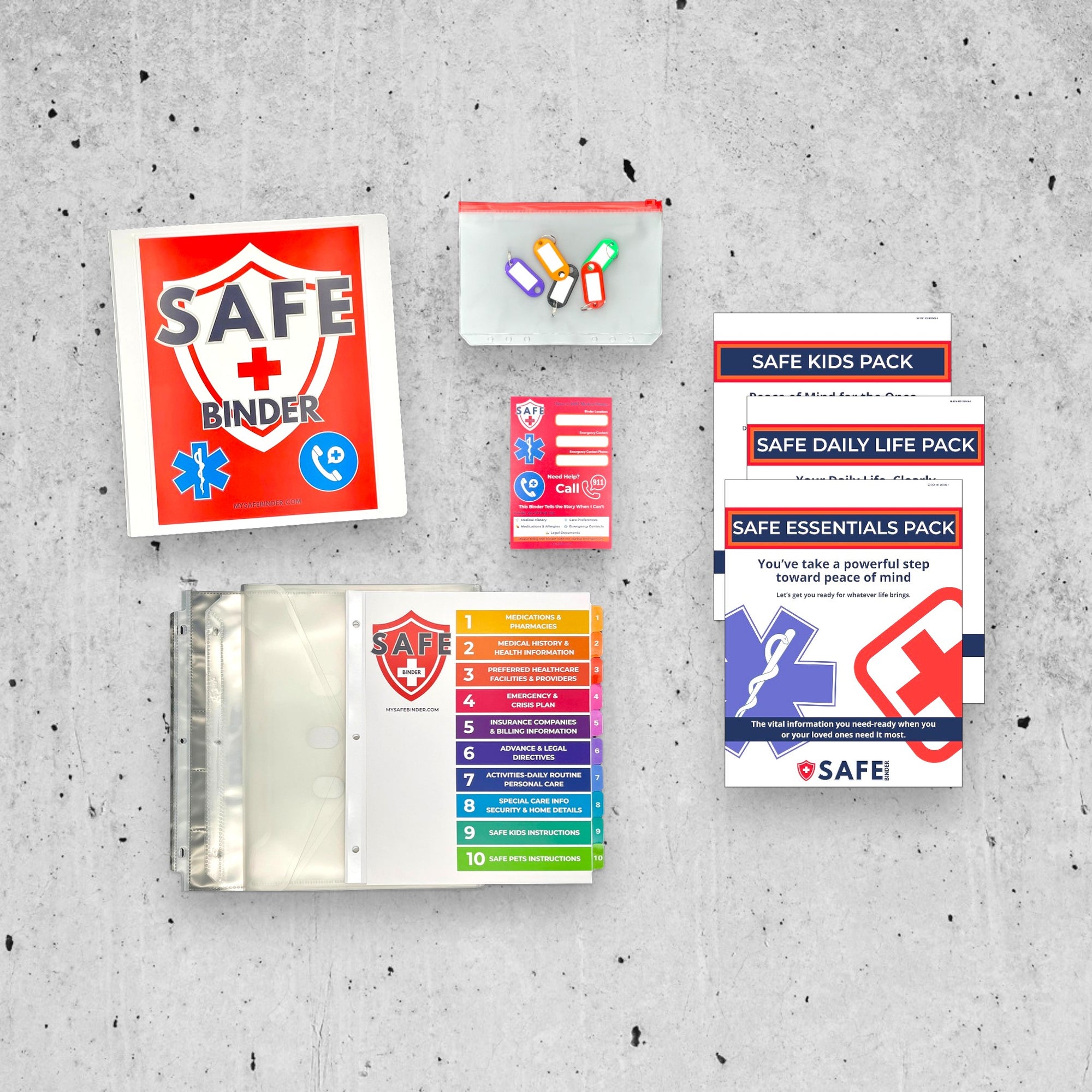 White SAFE Binder with SAFE Kids Pack and included materials on a concrete background