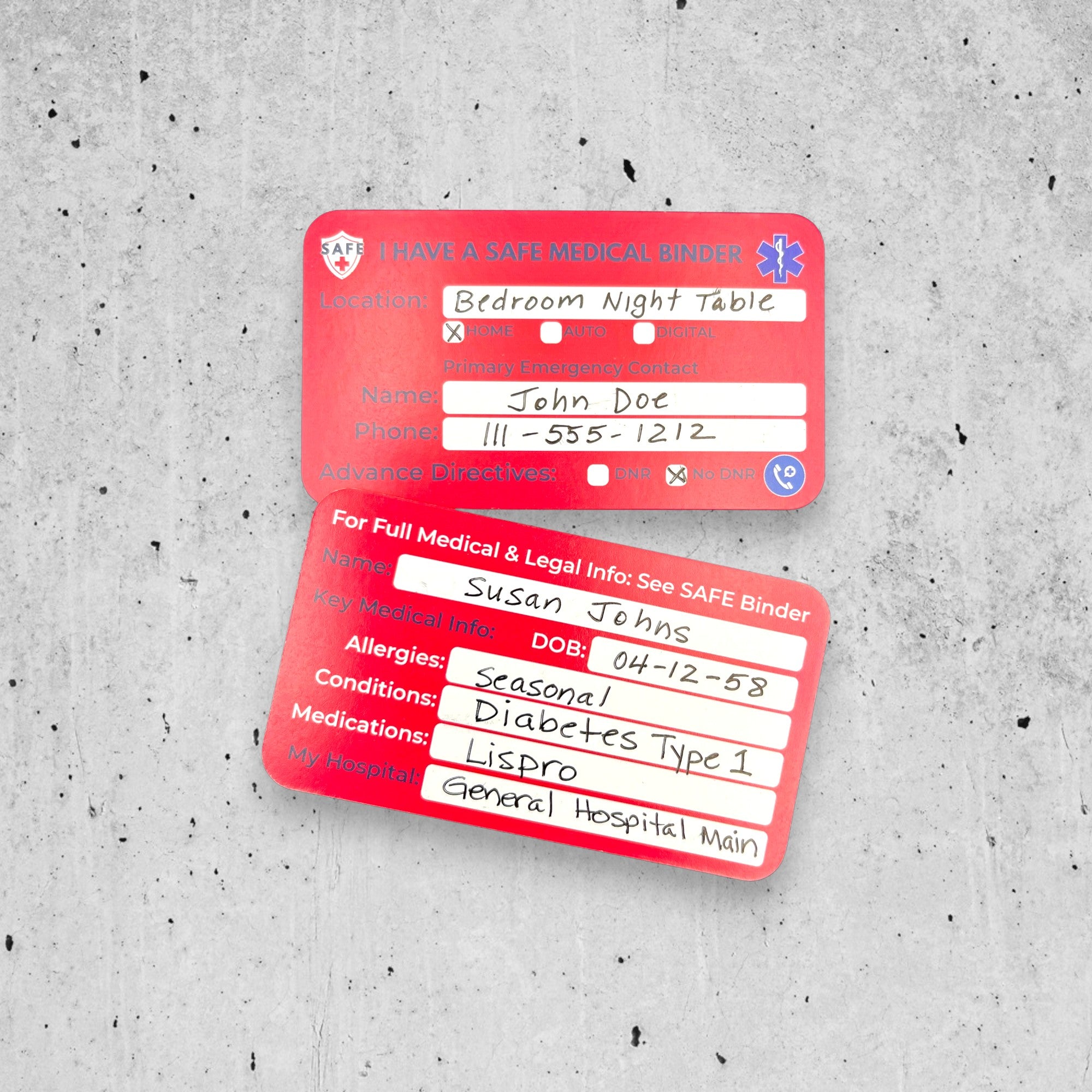 Two red medical information cards on a textured gray concrete background